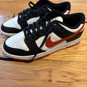 Nike Black and White Shoes with Orange Swoosh